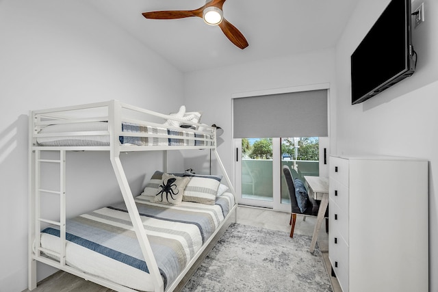 bedroom featuring hardwood / wood-style flooring, ceiling fan, and access to outside