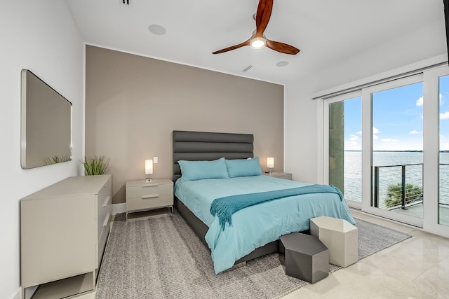 bedroom with a water view, access to exterior, and ceiling fan