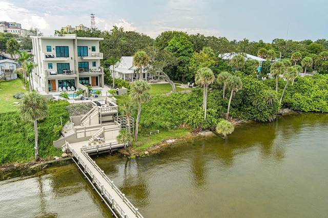 dock area with a water view and a balcony