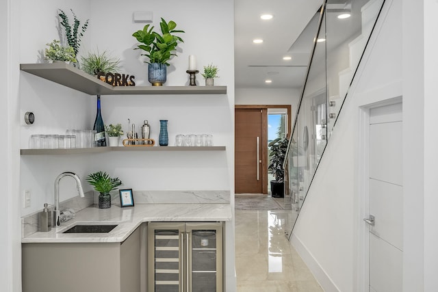 bar featuring beverage cooler and sink