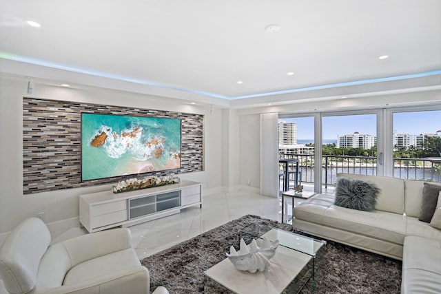 living area featuring baseboards and recessed lighting