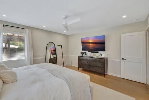 bedroom with light wood-type flooring and ceiling fan