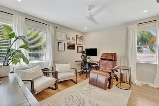 living area with light hardwood / wood-style flooring, plenty of natural light, and ceiling fan