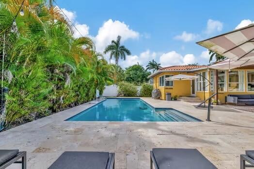 view of swimming pool featuring a patio area