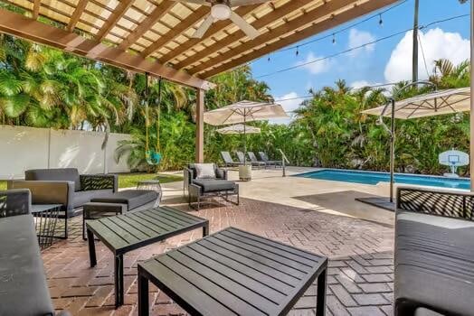 view of patio with a fenced in pool, an outdoor hangout area, and ceiling fan