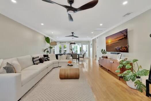 living room featuring ornamental molding and hardwood / wood-style flooring