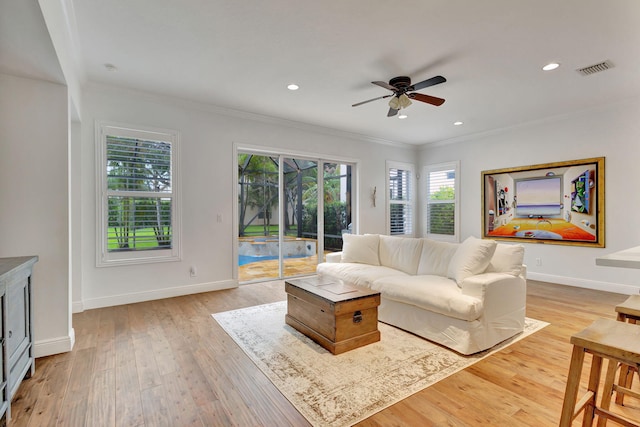 living room with crown molding, ceiling fan, and light hardwood / wood-style floors