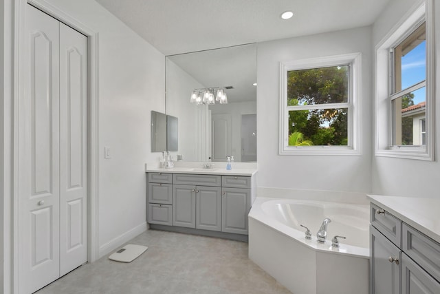9232 Nugent Trl, West Palm Beach, FL 33411 - full bathroom with vanity, a bath, a chandelier, and tile patterned floors