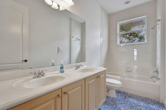 full bathroom with tiled shower / bath combo, tile patterned floors, vanity, and toilet