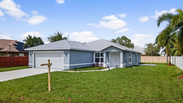 ranch-style home featuring a front yard and a garage