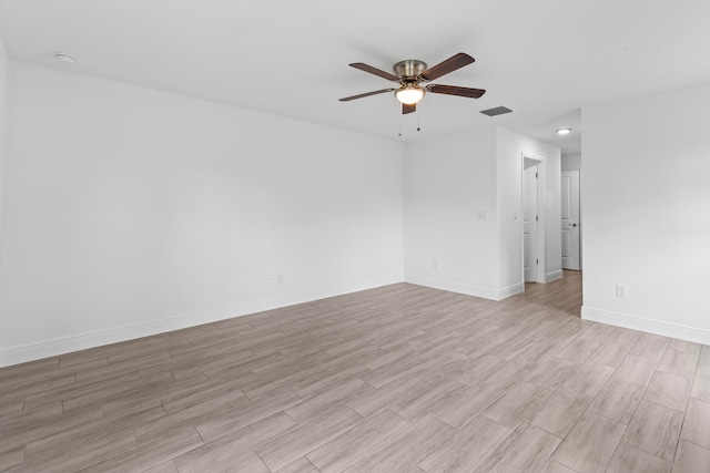 spare room with ceiling fan and light wood-type flooring