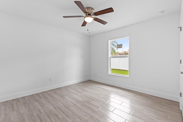 empty room featuring light wood-type flooring and ceiling fan