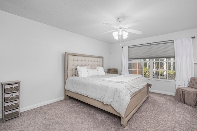 carpeted bedroom with ceiling fan and a textured ceiling