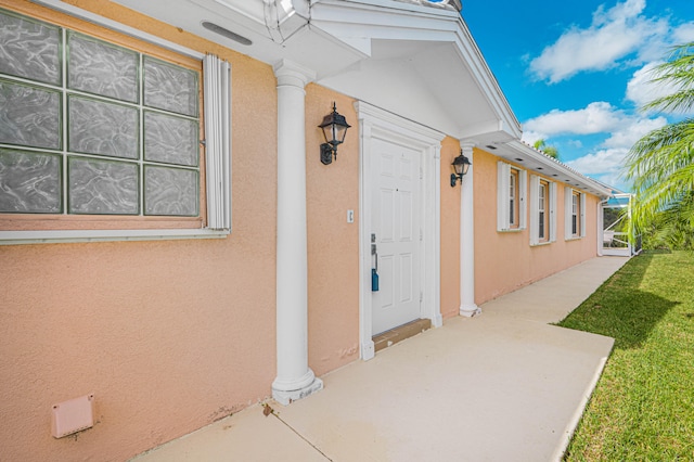 entrance to property with a yard