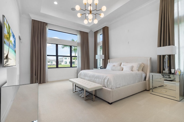 carpeted bedroom with an inviting chandelier, baseboards, a tray ceiling, and ornamental molding