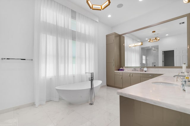 full bath featuring marble finish floor, a healthy amount of sunlight, and a freestanding bath