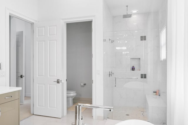 full bath with vanity, a marble finish shower, and toilet