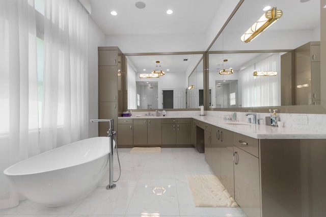 full bathroom with a freestanding bath, marble finish floor, vanity, and recessed lighting