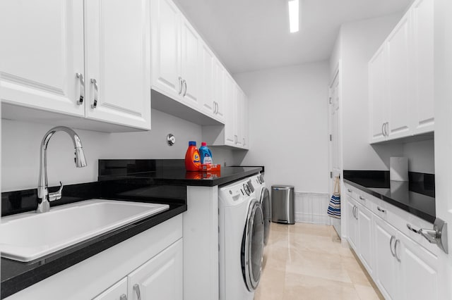 clothes washing area featuring cabinet space, wainscoting, a sink, and independent washer and dryer