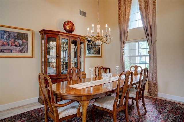 dining space with a chandelier, hardwood / wood-style floors, and a wealth of natural light