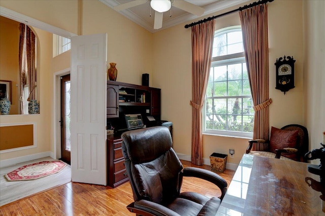 office area with light hardwood / wood-style floors, ornamental molding, and ceiling fan