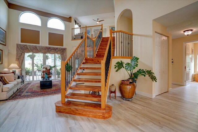 9863 Royal Cardigan Way, West Palm Beach, FL 33411 - living area featuring a chandelier, a high ceiling, wood finished floors, healthy amount of natural light, and baseboards