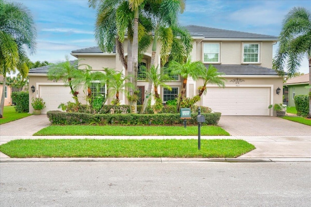 view of front facade with a garage and a front yard