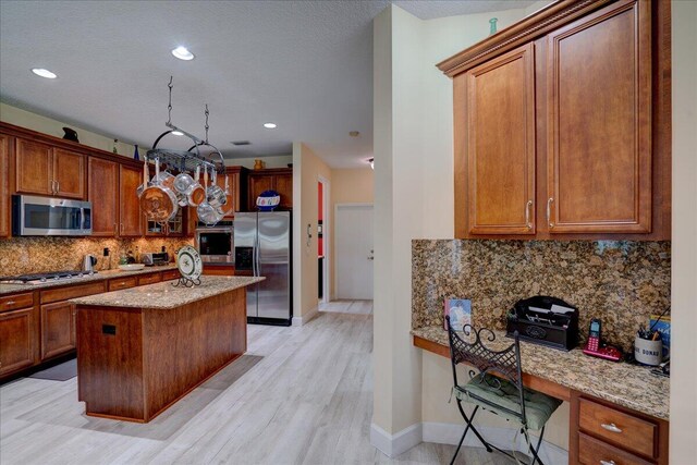 9863 Royal Cardigan Way, West Palm Beach, FL 33411 - kitchen featuring appliances with stainless steel finishes, a sink, brown cabinets, recessed lighting, and ornamental molding