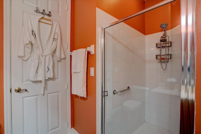 bathroom featuring a shower with door