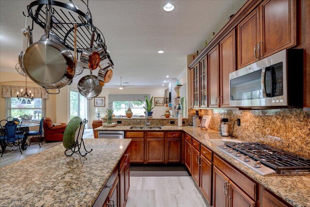 9863 Royal Cardigan Way, West Palm Beach, FL 33411 - kitchen with stainless steel appliances, backsplash, light wood finished floors, a center island, and recessed lighting