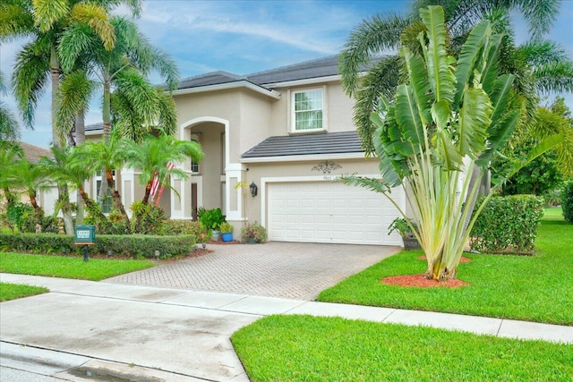 view of front of property featuring a front yard and a garage