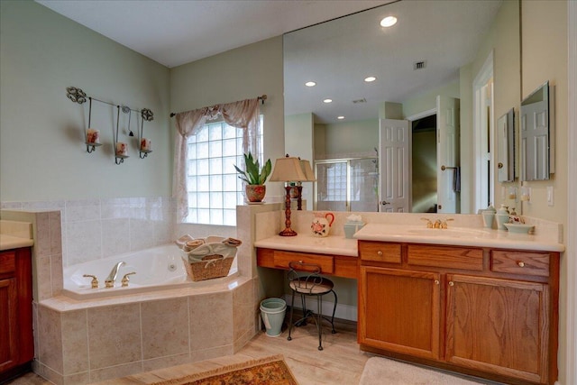 bathroom with hardwood / wood-style floors, vanity, and plus walk in shower