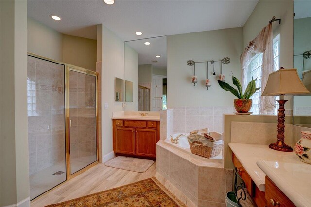 9863 Royal Cardigan Way, West Palm Beach, FL 33411 - bathroom featuring toilet, plenty of natural light, a tub with jets, vanity, and recessed lighting