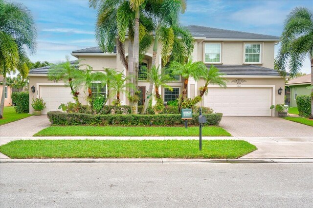 9863 Royal Cardigan Way, West Palm Beach, FL 33411 - view of front of house featuring decorative driveway, stucco siding, and a tiled roof