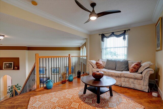 9863 Royal Cardigan Way, West Palm Beach, FL 33411 - living room with a ceiling fan, light wood-type flooring, healthy amount of natural light, ornamental molding, and a textured ceiling