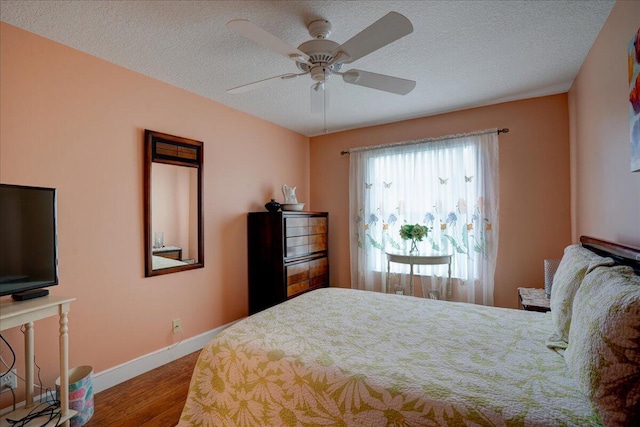 bedroom with wood-type flooring, a textured ceiling, and ceiling fan