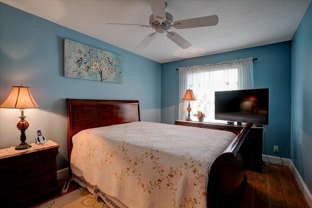 bedroom with ceiling fan, a textured ceiling, and hardwood / wood-style floors