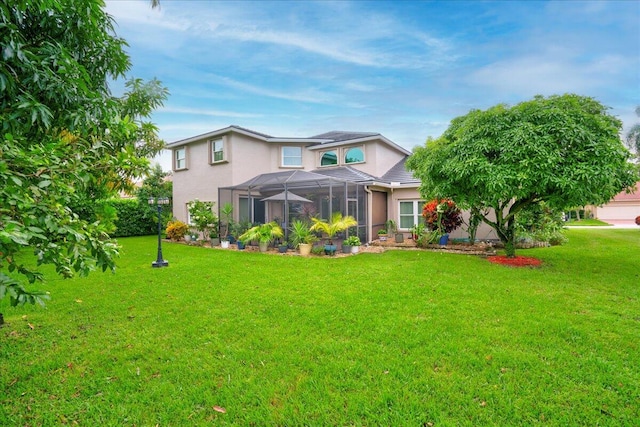 rear view of property with a lawn and a lanai