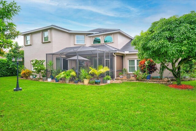 9863 Royal Cardigan Way, West Palm Beach, FL 33411 - view of front of property featuring stucco siding, a front lawn, and a lanai