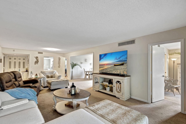 living room featuring light carpet and a textured ceiling