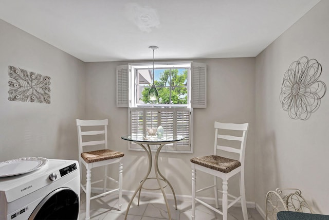 tiled dining room with washer / clothes dryer