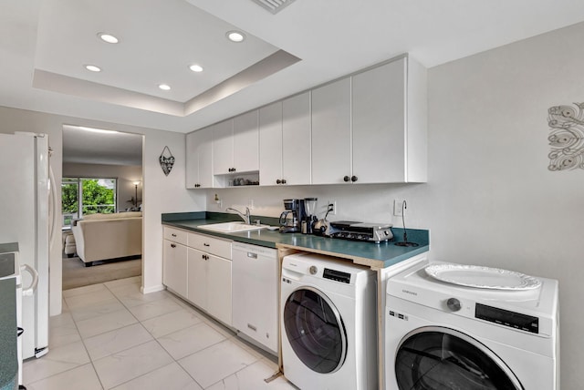 clothes washing area with sink and separate washer and dryer