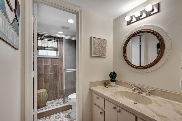 bathroom with toilet, an enclosed shower, vanity, and tile patterned flooring