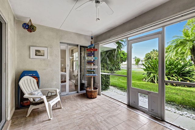 unfurnished sunroom with ceiling fan