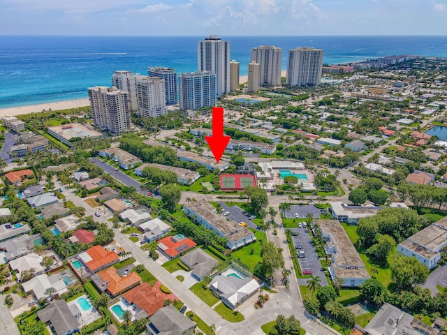 drone / aerial view with a water view and a view of the beach