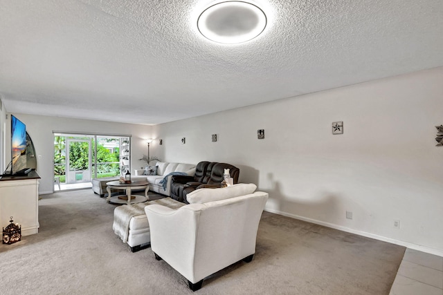 carpeted living room featuring a textured ceiling