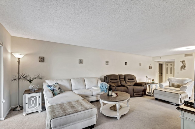 carpeted living room with a textured ceiling