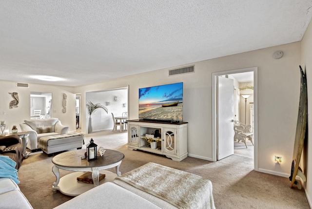 living room featuring a textured ceiling and light colored carpet