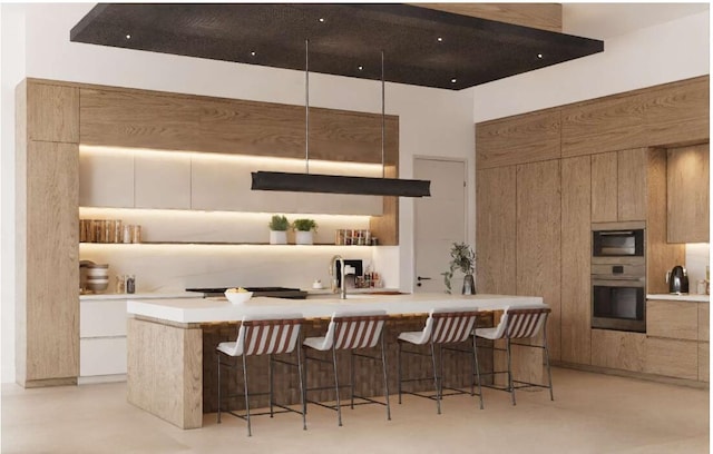 kitchen featuring white cabinets, appliances with stainless steel finishes, and a breakfast bar area