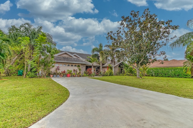 ranch-style house featuring a garage and a front lawn